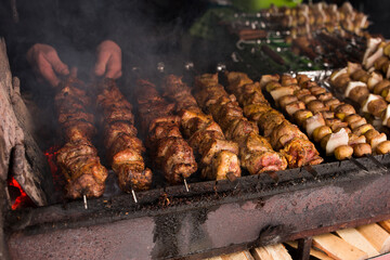 Meat and potatoes with lard on skewer, cooked on the grill, fragrant atmosphere of street food.