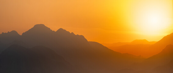 orange panorama - misty mountains at sunset