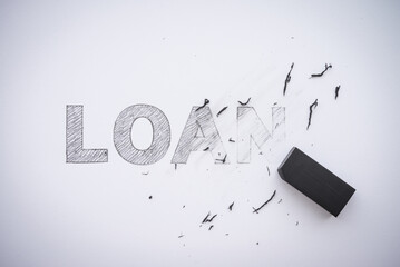 Word pencil hand writing LOAN is deleted by black eraser on white paper background copy space. Business and financial, economy or personal money management concept.