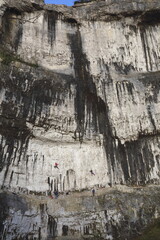 Rock climbing on a shear limestone rock face.