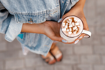 person holding a cuo of hot chocolate