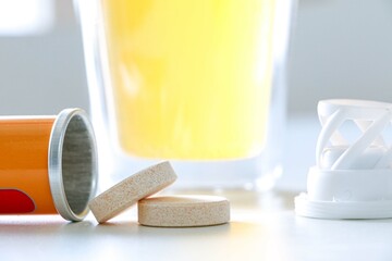 Health supplements, vitamin C dissolvable tablets fallen out of a tube, vitamin c drink in...