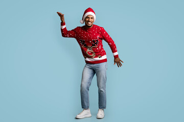 Funny black guy celebrating Christmas on blue background