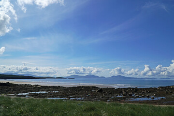 The beach at Abeffraw, Anglesey, Wales, with the mountains of Snowdonia in the distance