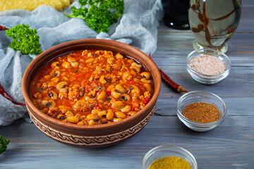Chili con carne in a bowl on wooden background. Mexican cuisine