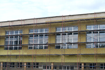 Insulating facade of the public school. Improving energy efficiency of the building. 