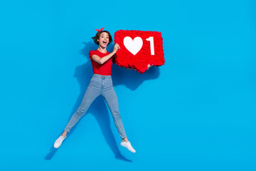 Full size photo of young excited girl jumper paper pinata feedback popular click isolated over blue color background