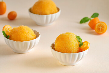 Obraz na płótnie Canvas Orange ice cream sorbet served with kumquat . Closeup