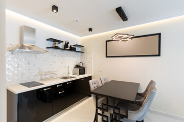 Interior of a modern new kitchen with dining table and chairs