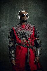 Vintage style portrait of stylish dark skinned man, medieval warrior or knight in sunglasses and...