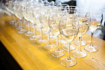 Several of clean wine glasses exposed bartender on the bar during the event. S