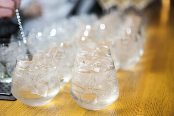 transparent alcohol in a glass with ice