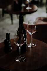 wine glasses and bottles of wine in the entourage of the wine bar in the evening