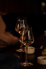 wine glasses and bottles of wine in the entourage of the wine bar in the evening