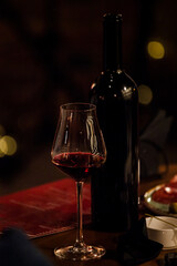 wine glasses and bottles of wine in the entourage of the wine bar in the evening