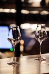 wine glasses and bottles of wine in the entourage of the wine bar in the evening