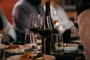 wine glasses and bottles of wine in the entourage of the wine bar in the evening