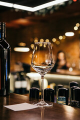 wine glasses and bottles of wine in the entourage of the wine bar in the evening