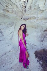 woman in a pink dress on the beach in milos greece model shooting 