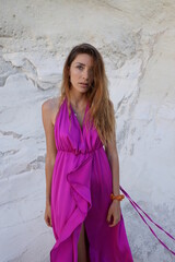 woman in a pink dress on the beach in milos greece model shooting 