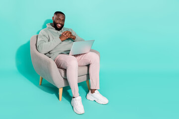 Fototapeta na wymiar Full length body size view of handsome trendy cheery guy using laptop work isolated over shine teal turquoise color background