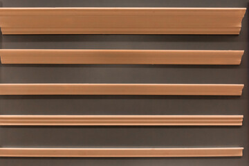 Brown ceiling skirting board material for repair and interior design of the corners of the ceiling of the house inside