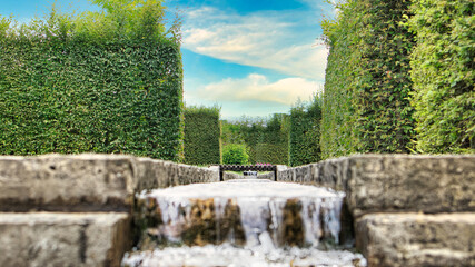 waterfall over a stone staircase. a stream flowing through a park.