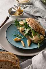 Homemade sandwiches with fresh cheese, arugula and mushrooms