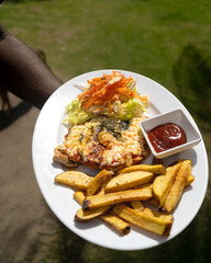 pescado frito, toston, comida tradicional de la costa colombiana, comida deliciosa, en platos blancos con fondos de madera. fideos a la pescadora, todo sobre la costa.
