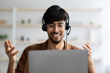 Portrait of smiling arabic guy having video chat