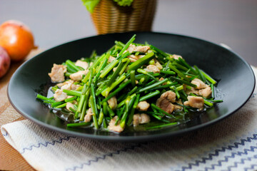 Stir-fried morning glory in a black dish 