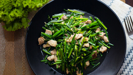 Stir-fried morning glory in a black dish 