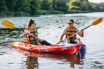 Obraz premium Couple together kayaking on the river