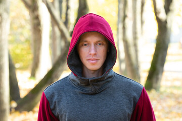 Sporty man walking in autumn park 