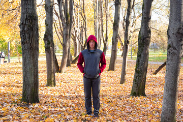 Sporty man walking in autumn park 