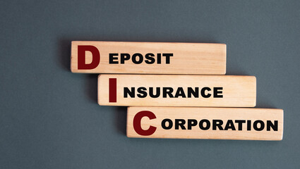 DIC - acronym on wooden bars on a gray background