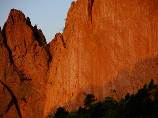 Red and orange monolithic sandstone cliffs at sunrise in Garden of the Gods Colorado Springs