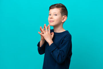 Little kid boy isolated on blue background scheming something