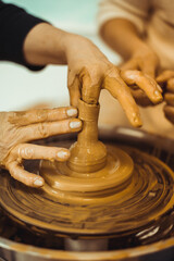 A man working on a potter's wheel. Creative work with clay.