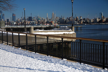 Midtown Manhattan and the Empire State Building with the snow from Hudson River Walkaway