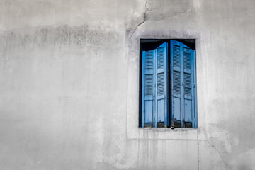 European street. Wooden shutters. Facade of a residential building. Travel in Europe. Open and closed shutters. French windows.