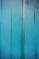 Fototapeta na wymiar Shabby and very old green-blue wooden fence.