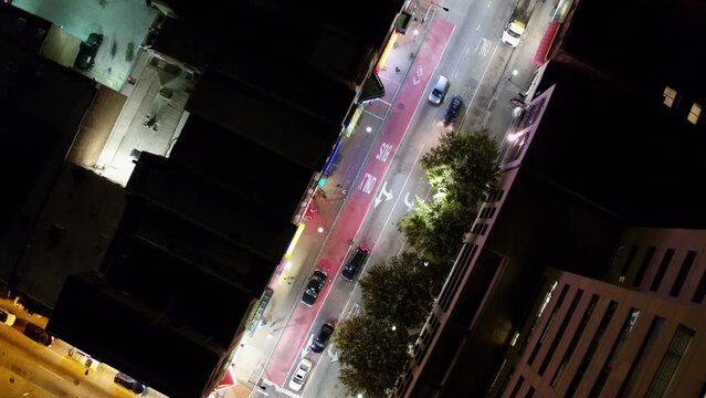 Aerial Top Panning Shot Of Cars And People Moving On City Street At Night - Baltimore, Maryland