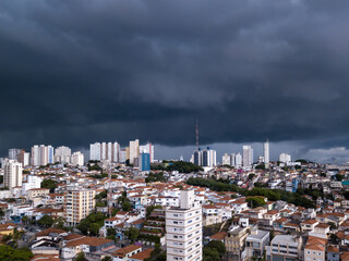 Dramatic drone aerial view of summer rain clouds in Pompeia neighborhood buildings and houses in...