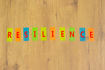 Resilience success symbol. The concept word Resilience on colored papers on a beautiful wooden background. Business and resilience success concept, copy space.