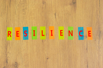 Resilience success symbol. The concept word Resilience on colored papers on a beautiful wooden background. Business and resilience success concept, copy space.