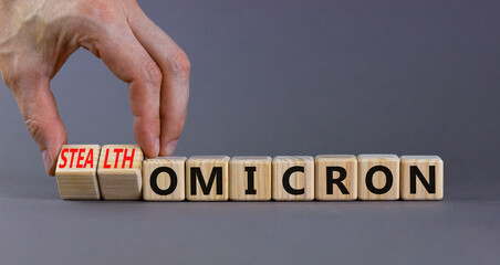 Covid-19 stealth omicron symbol. Doctor turns cubes and changes words omicron to stealth omicron....