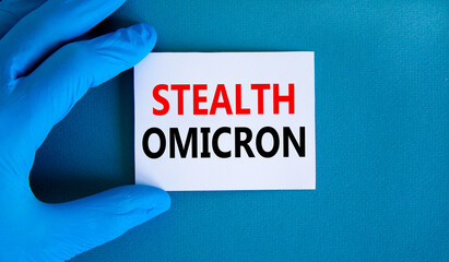 New covid-19 stealth omicron variant strain symbol. Hand in blue glove with white card. Concept...
