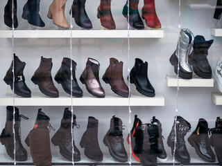 Display of natural leather shoes in the window store.