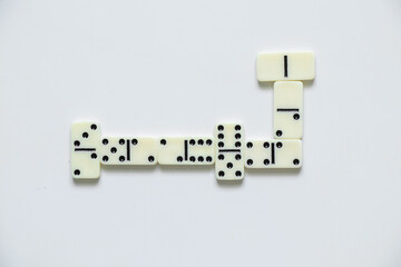 dominoes on a white background close up, domino effect